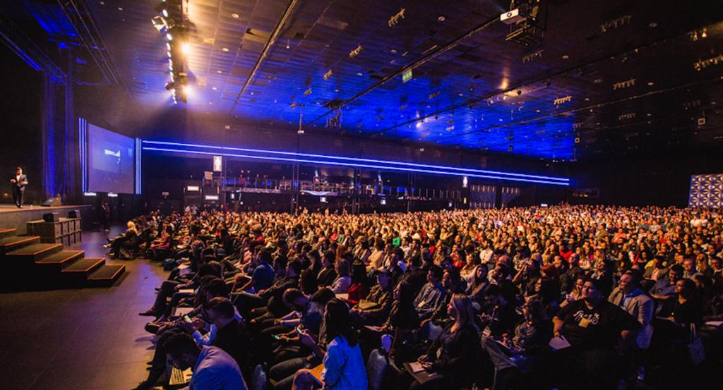 A large audience during a speech in an auditorium.